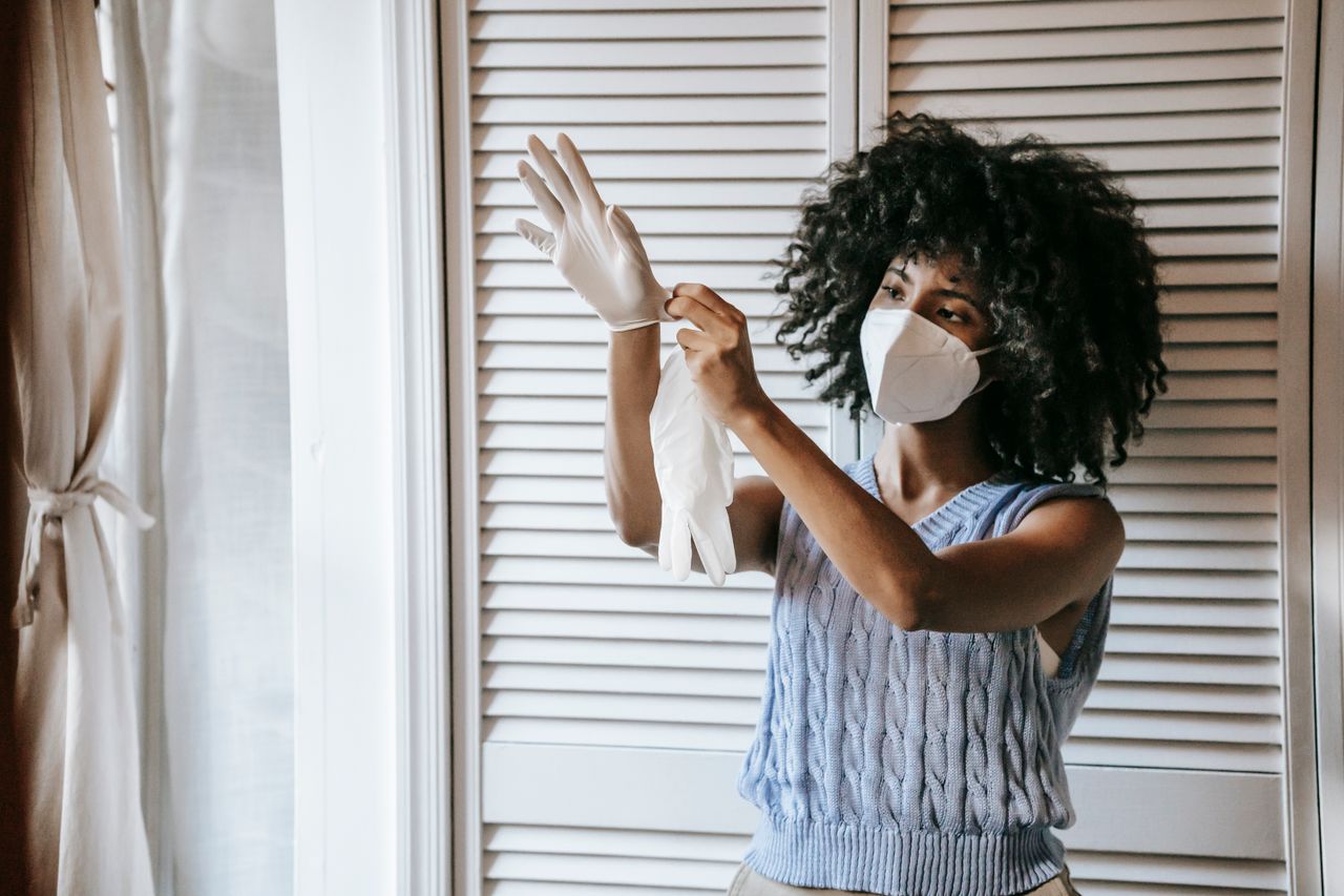 Crafting Captivating Headlines: Your awesome post title goes here Young African American female in casual outfit and protective face mask putting off medical rubber gloves